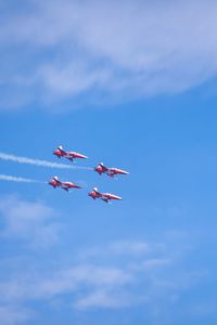 Low angle view of bird flying against sky airpower 2022