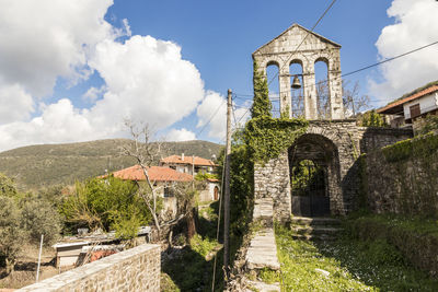 Panoramic view of historic building by mountains against sky