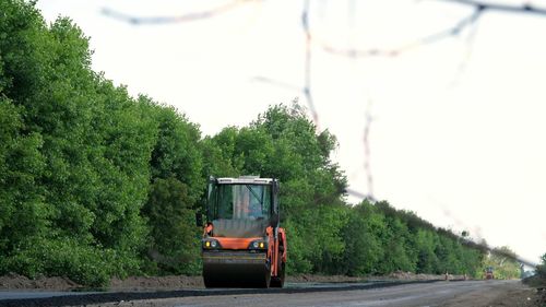 Road construction works with roller compactor machine and asphalt finisher. 