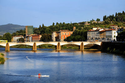 Ponte alle grazie over arno river at tuscany against clear sky