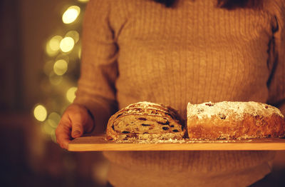 Midsection of woman holding cookies