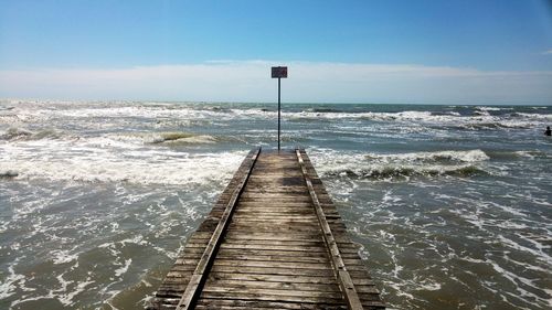 Pier over sea against sky