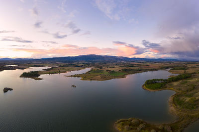 Scenic view of lake against sky during sunset