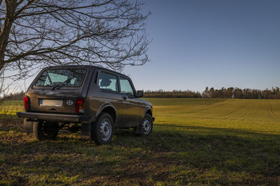 Car on field against sky