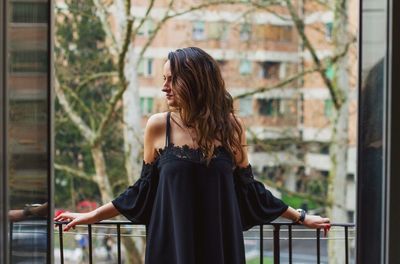 Young woman with arms raised