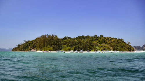 Scenic view of sea against clear blue sky