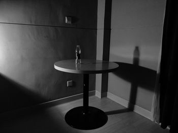 Water bottle on table against wall