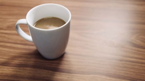 High angle view of coffee cup on table with copy space 