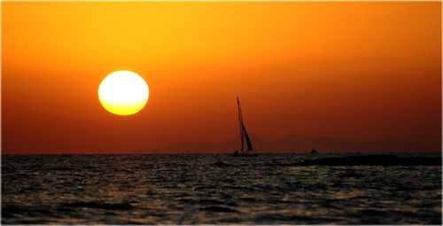 Scenic view of sea against orange sky