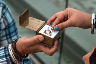 Wedding rings with two hands - taking wedding ring - man and woman