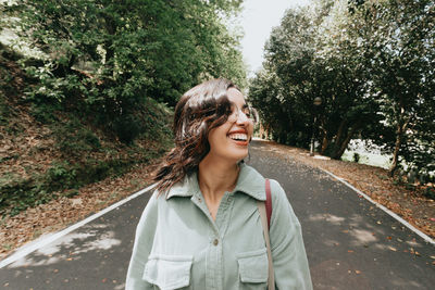 Portrait of young woman standing in forest