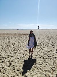 Rear view of man standing on beach