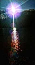 Scenic view of lake against bright sun