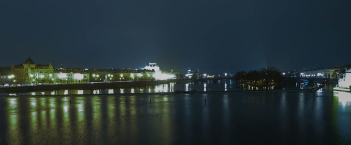 Illuminated city against sky at night