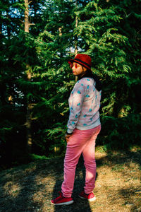 Rear view of man standing in forest