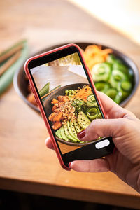 Close-up of hand holding food on table