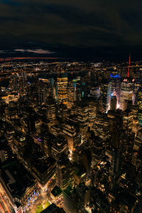 High angle view of illuminated buildings in city at night