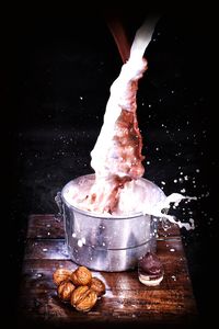 Person holding ice cream on barbecue grill