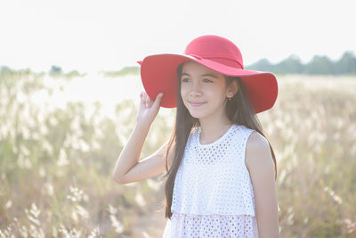 Portrait of smiling woman standing on field