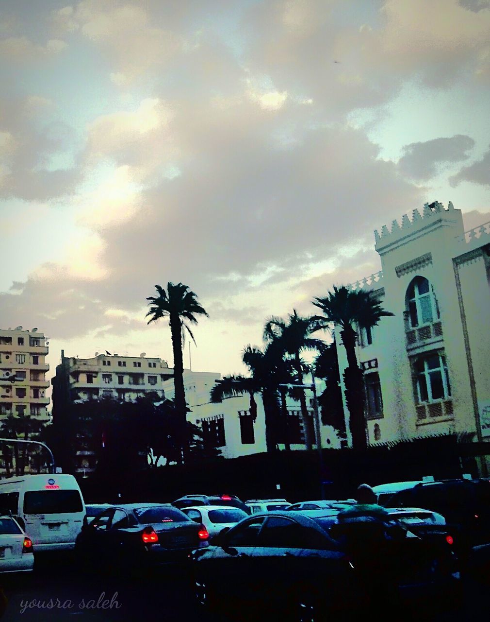 car, building exterior, transportation, land vehicle, mode of transport, architecture, built structure, sky, street, tree, city, cloud - sky, parking, road, stationary, parked, residential building, cloudy, building, city street