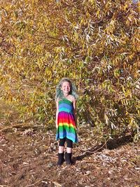 Portrait of young woman in forest during autumn