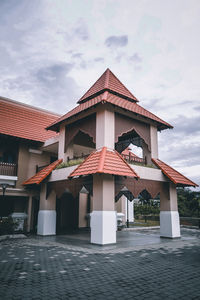 House by building against sky