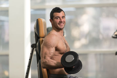 Muscular man exercising in gym