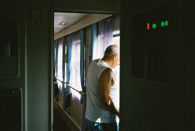 Man looking through window