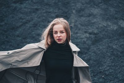 Portrait of beautiful young woman standing outdoors