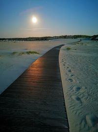 Scenic view of beach against sky during sunset