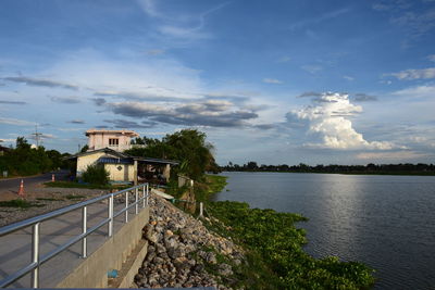 Scenic view of lake by building against sky