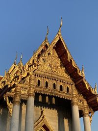 Low angle view of historical building against clear blue sky