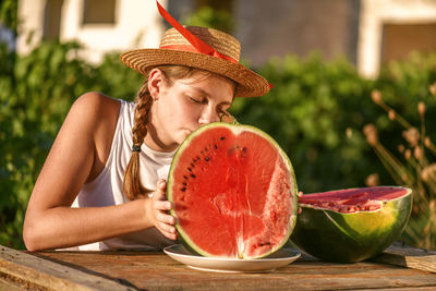 Happy smiling girl with half red fresh watermelon enjoying summer life outdoors. summer lifestyle