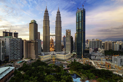 View of cityscape against cloudy sky