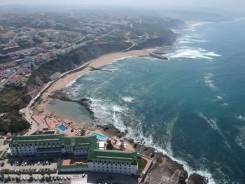 High angle view of buildings by sea