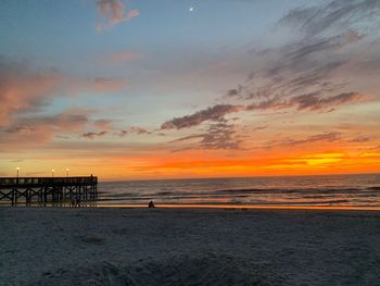 Scenic view of beach against sky during sunset