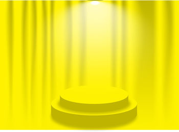 Close-up of yellow light bulb on table