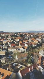 High angle view of houses in town against sky