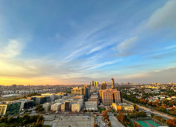 High angle view of buildings in city against sky during sunset