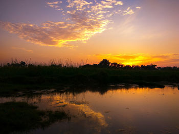 Scenic view of lake against orange sky