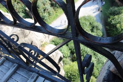 Close-up of metal fence by railing