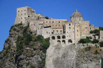 Low angle view of historic building against blue sky