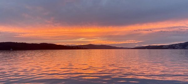 Scenic view of lake against romantic sky at sunset