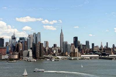 View of buildings in city against cloudy sky