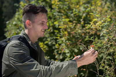 Side view of young man looking at field