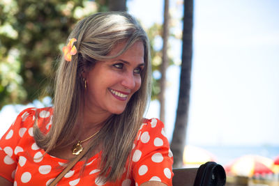 Close-up of smiling woman looking away