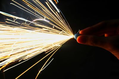 Person holding illuminated lighting equipment