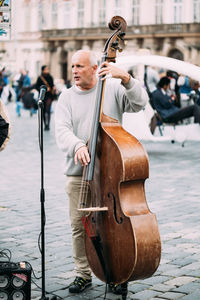 Man playing guitar in city