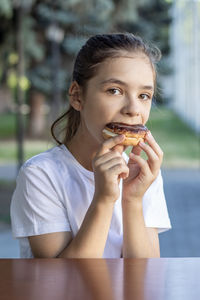 Close-up of young woman eating food