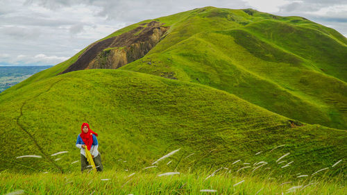 Full length of man walking on mountain against sky